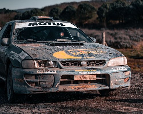 Smartphone showing the fictional Neon Workshop Rally speed challenge